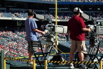 people capturing sports using professional cameras