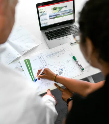 Two people discussing a diagram